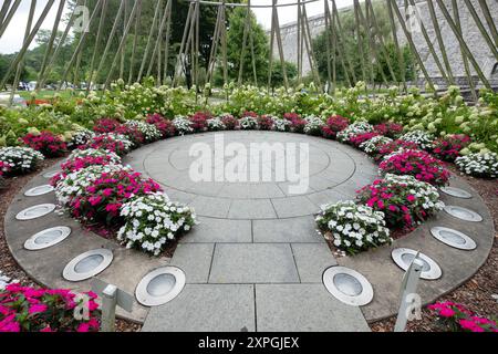 Ornate flowers arranged at the base of The Rise, a statue in Kensico Dam Plaza honoring people from Westchester killed on 9/11. In Valhalla. Stock Photo