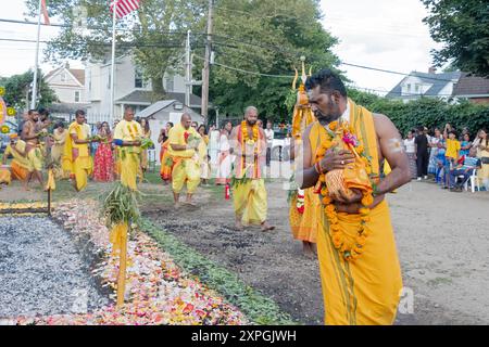 Before the Thimithee fire walking ritual high priest from Reunion Island leads worshippers around the hot burning coals. In Jamaica, Queens NY. Stock Photo