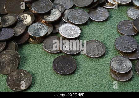 Terengganu, malaysia - 23 August 2024 : Closeup of scattered malaysian coins on green background Stock Photo