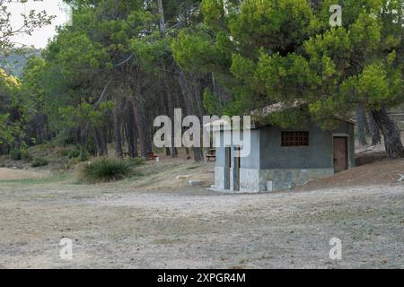 Mariola Fountain Recreation Area with public toilet building and wooden picnic areas under the forest, Bocairente, Spain Stock Photo