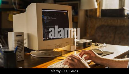 Caucasian Male College Student Using Old Desktop Computer In Nineties Retro Garage. Young Programmer Connecting World Wide Web Via Early Internet Software, Exploring Global Network. Stock Photo