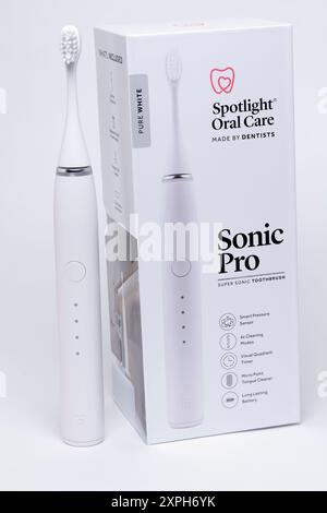 Battery Operated Toothbrush New Pure White  Sonic Pro with 4 Speed Settings and Box on a White Background Stock Photo