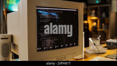 Close Up Shot Of Old Desktop Computer On Work Desk Of Software Developer In Retro Garage. Dated PC Has Operating System Terminal Opened, Prompts Running On Screen, Code Functioning Successfully. Stock Photo