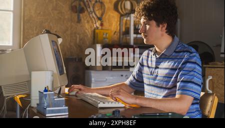Caucasian Male Software Engineer Programming On Old Desktop Computer In Retro Garage. Enthusiast Browsing Early Internet Forums, Coding Applications In Nineties. Nostalgia Concept Stock Photo