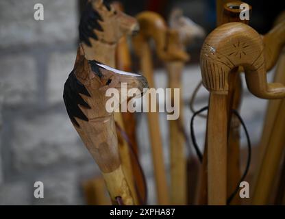 Handcrafted wooden walking sticks on display in Megalo Chorio, Evrytania, Greece. Stock Photo