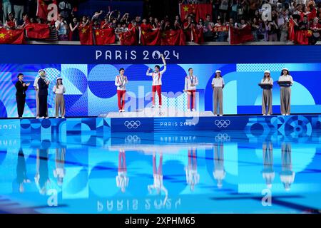 China's Quan Hongchan (centre) on the podium with the gold medal, alongside China's Chen Yuxi (left) with silver and North Korea's Kim Mi-rae with bronze after the Women's 10m Platform Final at the Aquatics Centre on the eleventh day of the 2024 Paris Olympic Games in France. Picture date: Tuesday August 6, 2024. Stock Photo