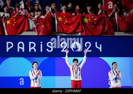 China's Quan Hongchan (centre) on the podium with the gold medal, alongside China's Chen Yuxi (left) with silver and North Korea's Kim Mi-rae with bronze after the Women's 10m Platform Final at the Aquatics Centre on the eleventh day of the 2024 Paris Olympic Games in France. Picture date: Tuesday August 6, 2024. Stock Photo