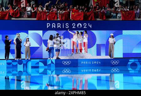 China's Quan Hongchan (centre) on the podium with the gold medal, alongside China's Chen Yuxi (left) with silver and North Korea's Kim Mi-rae with bronze after the Women's 10m Platform Final at the Aquatics Centre on the eleventh day of the 2024 Paris Olympic Games in France. Picture date: Tuesday August 6, 2024. Stock Photo