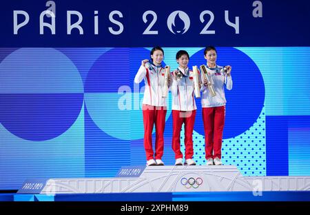 China's Quan Hongchan (centre) on the podium with the gold medal, alongside China's Chen Yuxi (left) with silver and North Korea's Kim Mi-rae with bronze after the Women's 10m Platform Final at the Aquatics Centre on the eleventh day of the 2024 Paris Olympic Games in France. Picture date: Tuesday August 6, 2024. Stock Photo