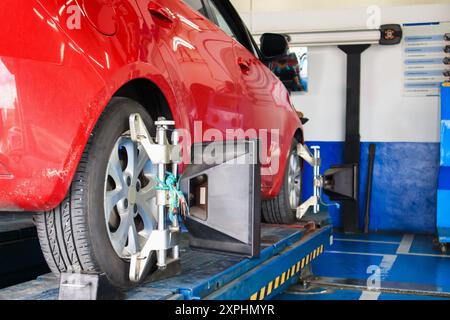 Car wheel alignment in progress at auto repair service centre Stock Photo