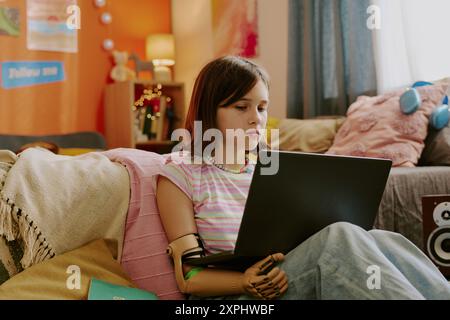 Teen Girl Doing Homework On Laptop Stock Photo