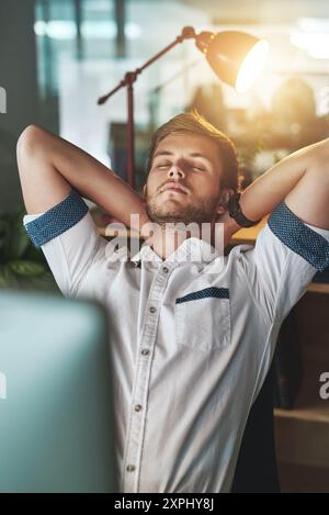 Tired, relax and businessman in office at night for IT overtime, programming or work fatigue. Burnout, exhausted and programmer on break by monitor Stock Photo