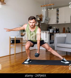 Young adult man doing home workout using dumbbells. Stock Photo