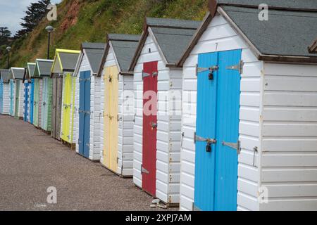 A row of colourful beach huts on the seafront at Seaton in Devon, Devonshire, England Stock Photo