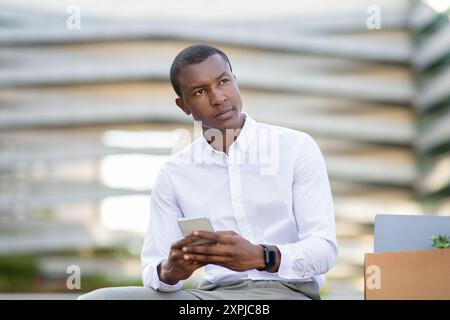 Young Professional Engaged in Communication While Sitting in Modern Area Stock Photo