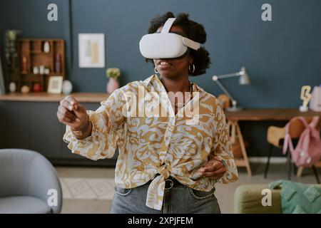 Using Virtual Reality Headset in Modern Living Room Stock Photo