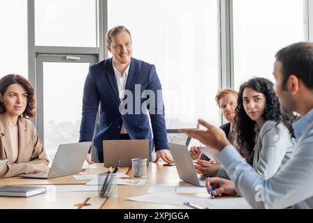 Business Professionals Discussing Ideas in Modern Office Setting Stock Photo