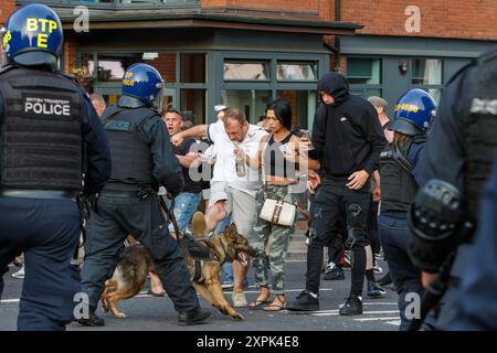 Bristol riot -  Police use police dogs to control and push back Far-right activists during an Enough is Enough protest in Bristol. 03-08-2024 Stock Photo