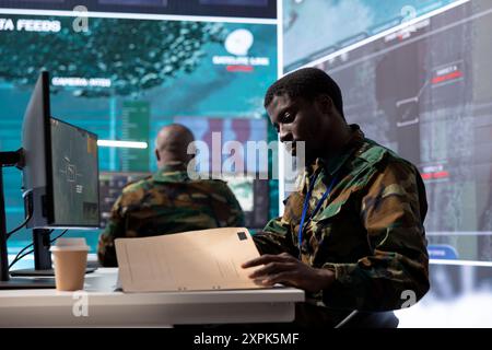 Control room, military documents and people on computer for ...