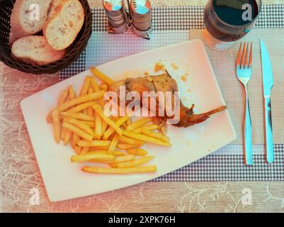 Braised rabbit served with potato garnish Stock Photo