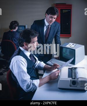 Retro computers in office, laboratory settings, showcasing early desktop technology, vintage monitors, keyboards, classic workplace computing environment Stock Photo