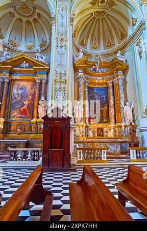 BERGAMO, ITALY - APRIL 7, 2022: Interior of Duomo di Bergamo (Bergamo Cathedral) with ornate side chapels, decorated with stone columns, sculptures, p Stock Photo