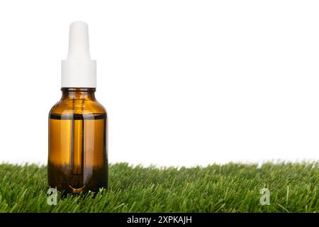 Amber Glass Dropper Bottle on Grass Stock Photo