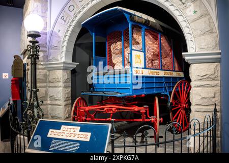 WASHINGTON DC, United States — A historical postal screen wagon, circa 1904, on display at the Smithsonian National Postal Museum in Washington DC. This artifact represents an important innovation in mail security and transportation from the late 19th to early 20th century, used to carry mail between railway stations and post offices in Maryland until the 1920s. Stock Photo