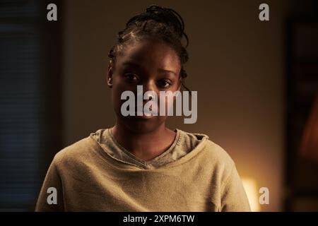 Young upset woman in casual pullover looking at camera with sad facial expression while suffering from domestic violence and abuse Stock Photo