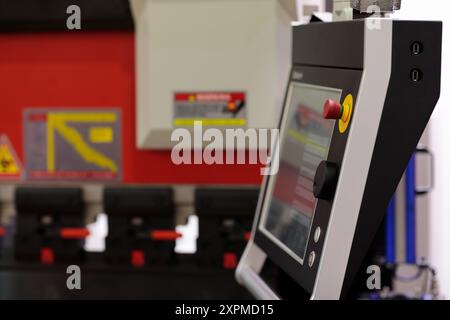 Touchscreen control console of modern CNC press brake machine. Selective focus. Stock Photo