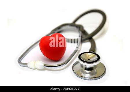 doctor stethoscope with red heart hand exercise ball Stock Photo