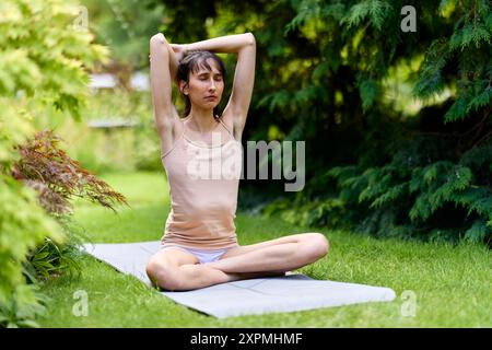 Woman practicing Yoga outdoors Stock Photo