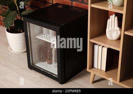 Modern mini refrigerator with drinks at home Stock Photo