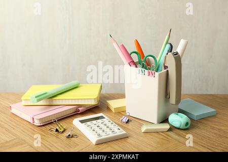 Stapler, holder and other different stationery on wooden table Stock Photo