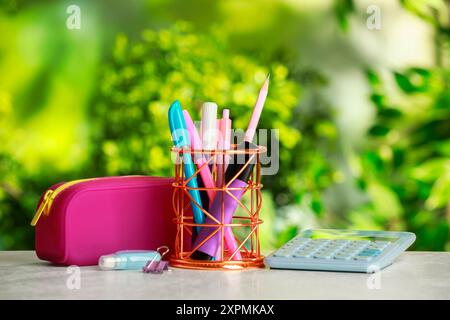 Holder, pencil case, calculator and other different stationery on white table Stock Photo