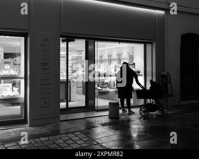 Arles, France - March 7, 2023: Empty street in the center of Arles (France) in the night, black and white Stock Photo