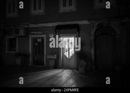 Cres, Croatia - October 23, 2022: Barbour shop in Cres in the night, black and white Stock Photo