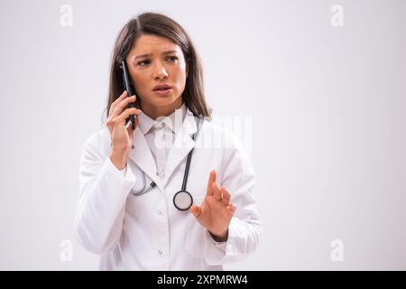 Portrait of doctor who is talking on phone with patient. Stock Photo