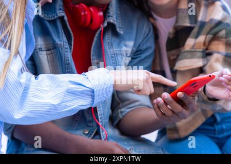 Three students having fun with mobile phones creating content on social media. Stock Photo