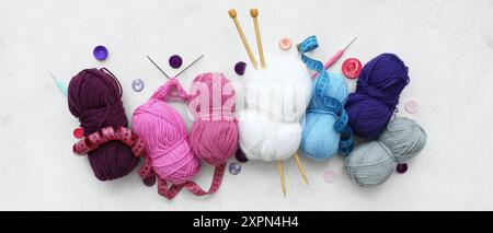 Yarn , knitting needles and buttons on light background Stock Photo