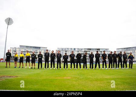 Bristol, UK, 7 August 2024. Gloucestershire line up to observe a minutes silence in memory of former Surrey and England batter Graham Thorpe during the Metro Bank One-Day Cup match between Gloucestershire and Sussex Sharks. Credit: Robbie Stephenson/Gloucestershire Cricket/Alamy Live News Stock Photo