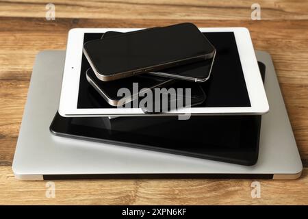 Stack of modern gadgets on wooden table Stock Photo