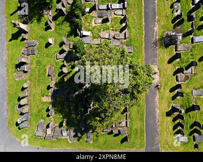 Aerial view looking down on fallen, broken gravestones Stock Photo