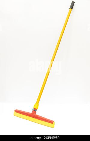 Yellow and Red Floor Squeegee with Handle Isolated on White Background Stock Photo