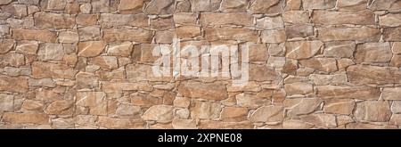 Brown wall cladding made of plastic in stone look - imitation of a stone wall Stock Photo