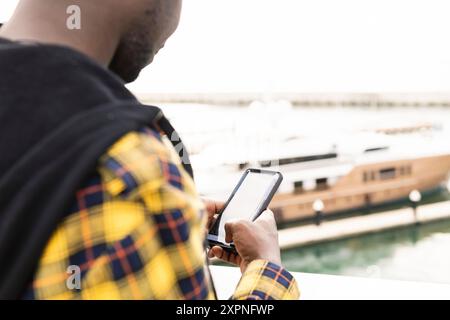 unrecognizable black man consulting his smartphone Stock Photo