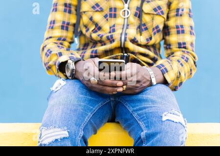 hands of a man writing a message on his phone Stock Photo
