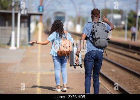 couple waiting the train on the dock Stock Photo