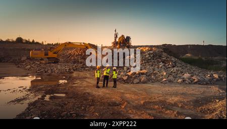 Aerial Drone Shot Of Construction Site With Excavators On Sunny Day: Diverse Team of Real Estate Developers Discussing Project. Engineer, Architect, Inspector Talking About New Building, Using Tablet. Stock Photo