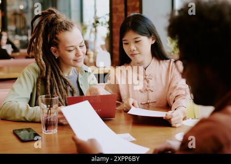 Collaborating in Modern Asian Fusion Restaurant Stock Photo